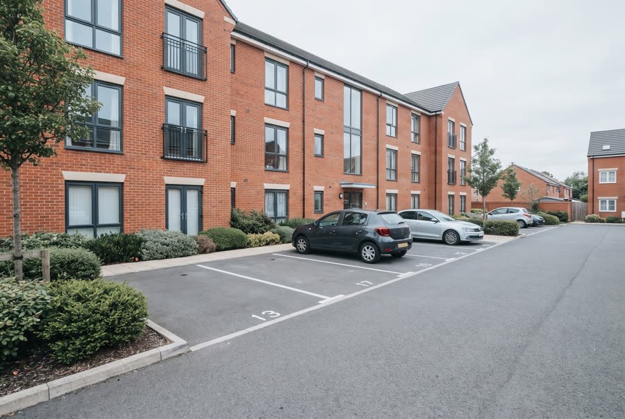 Allocated parking bays outside a modern block of flats